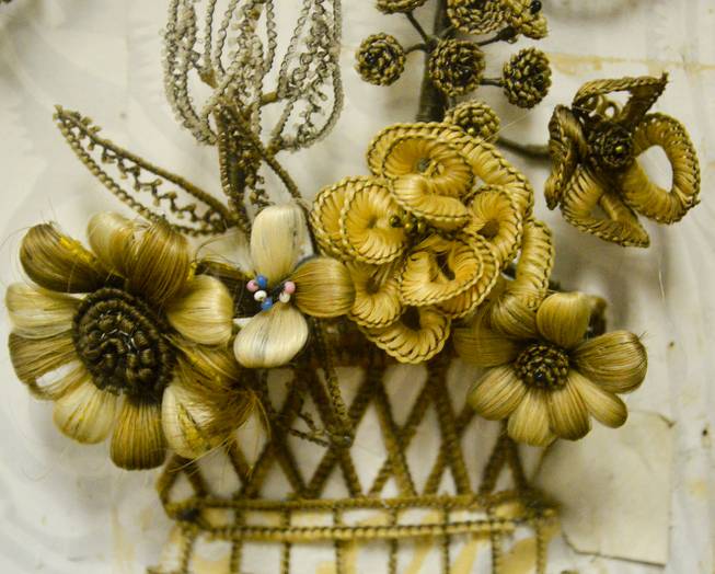 A closeup of a "hair wreath" in the Lyon County Museum in Yerington, Wednesday, Oct. 23, 2013. Making art of human hair was a Victorian era custom for mouring. The hair of deceased loved ones was taken and woven into wreaths. This one by Margaret Nichol was completed in 1860. It was loaned to the museum by area native Elouise Kettenburg.